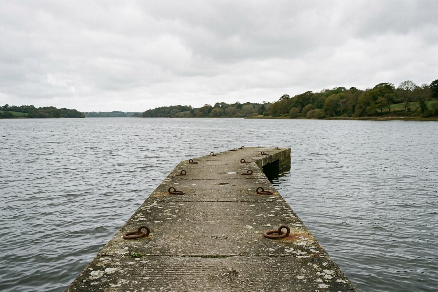 A short timber jetty running out over shallow water.