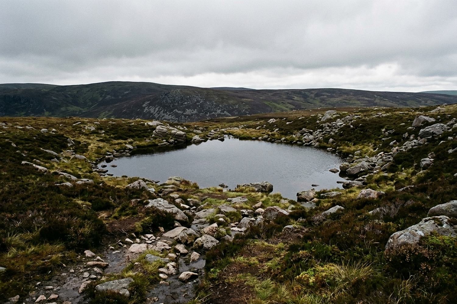 A small dark reservoir under granite tops.